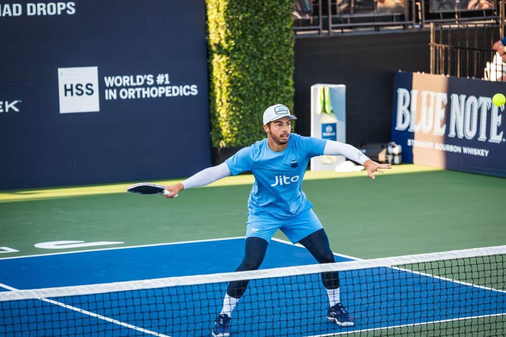 Pickleball player hitting the ball during a match at Major League Pickleball.