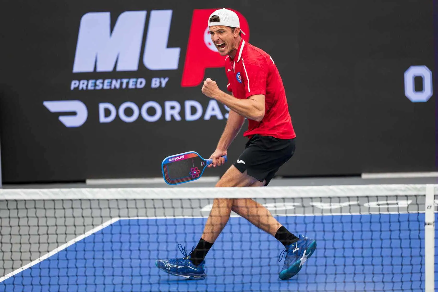 Player celebrating after winning a pickleball match at Major League Pickleball event.