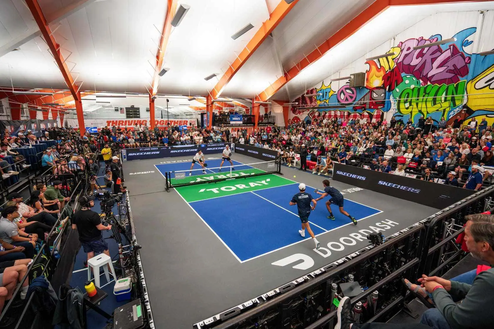 Pickleball players competing at Major League Pickleball event.
