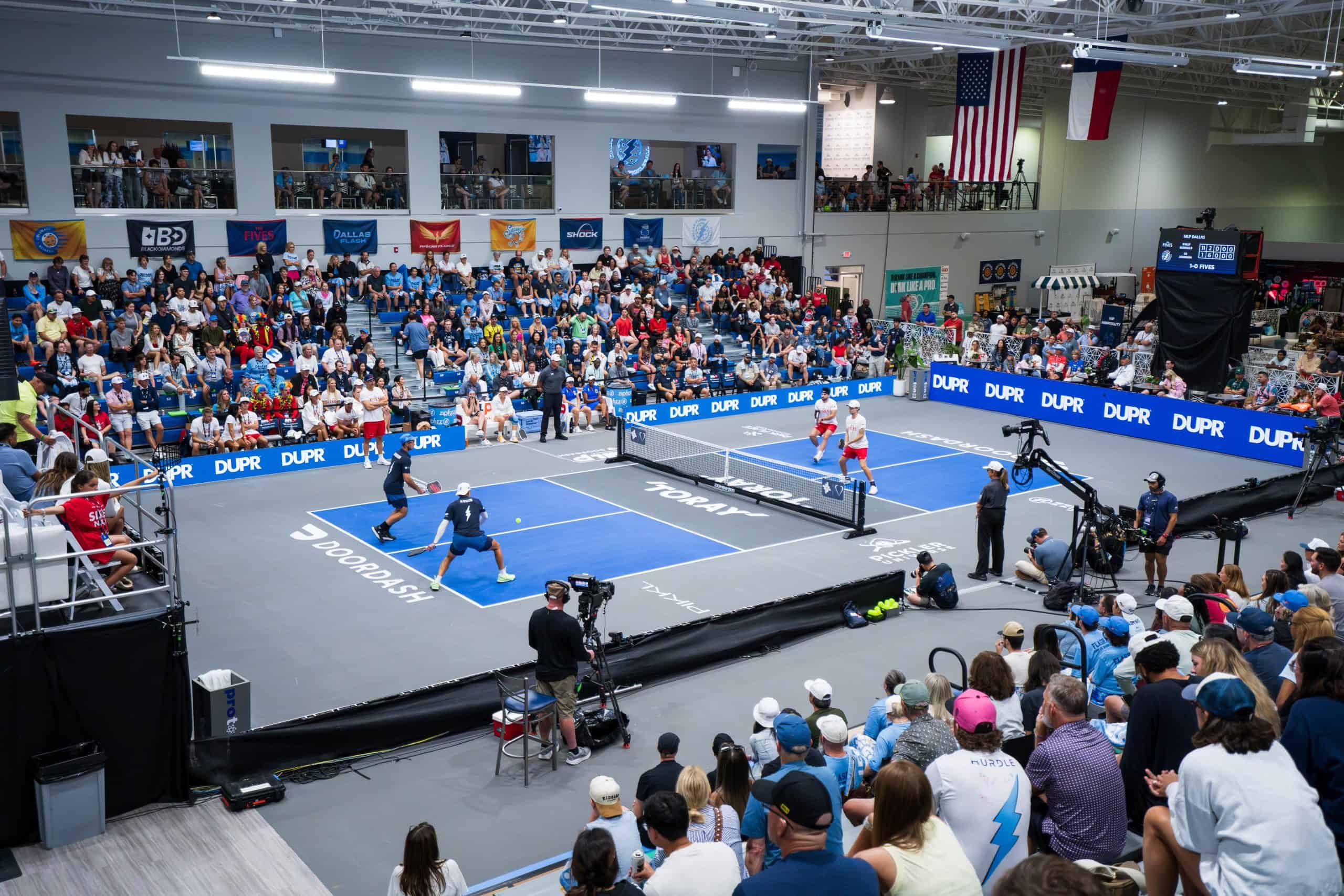 Exciting Major League Pickleball match with players and audience.