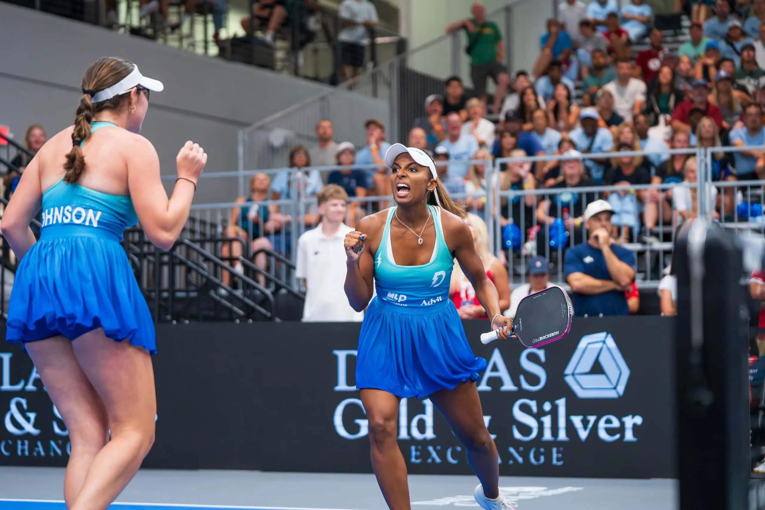 Two female pickleball players celebrating during a match at Major League Pickleball.