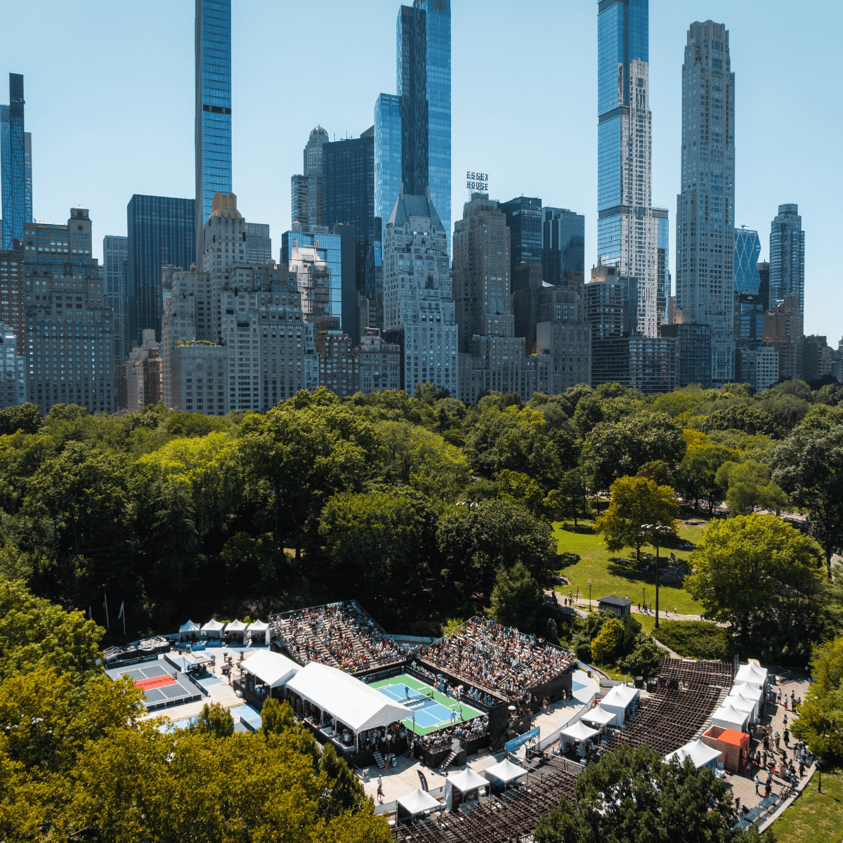 Outdoor pickleball tournament in Central Park with city skyline background.