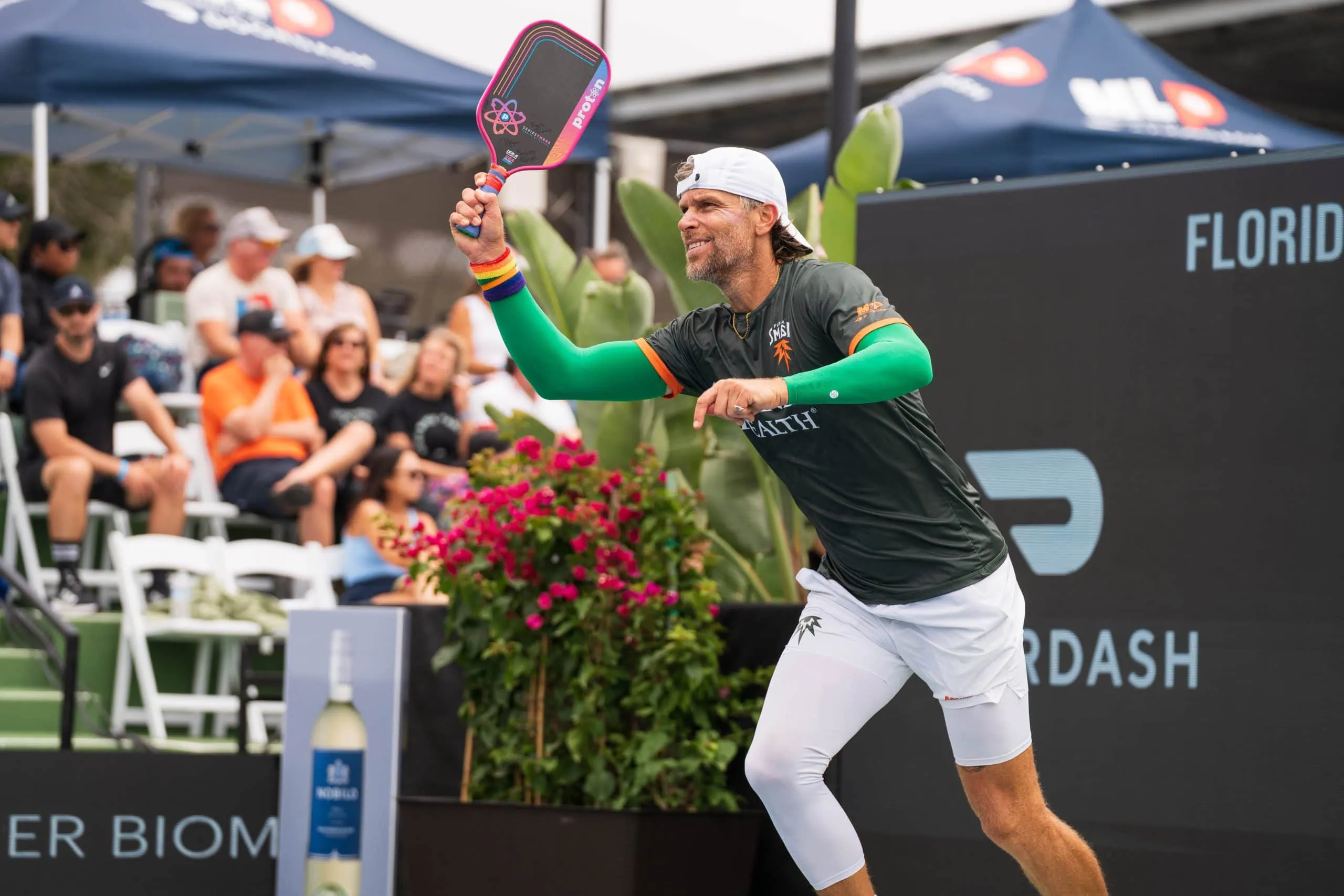 Pickleball player with paddle at Major League Pickleball event, showcasing competitive sports action.