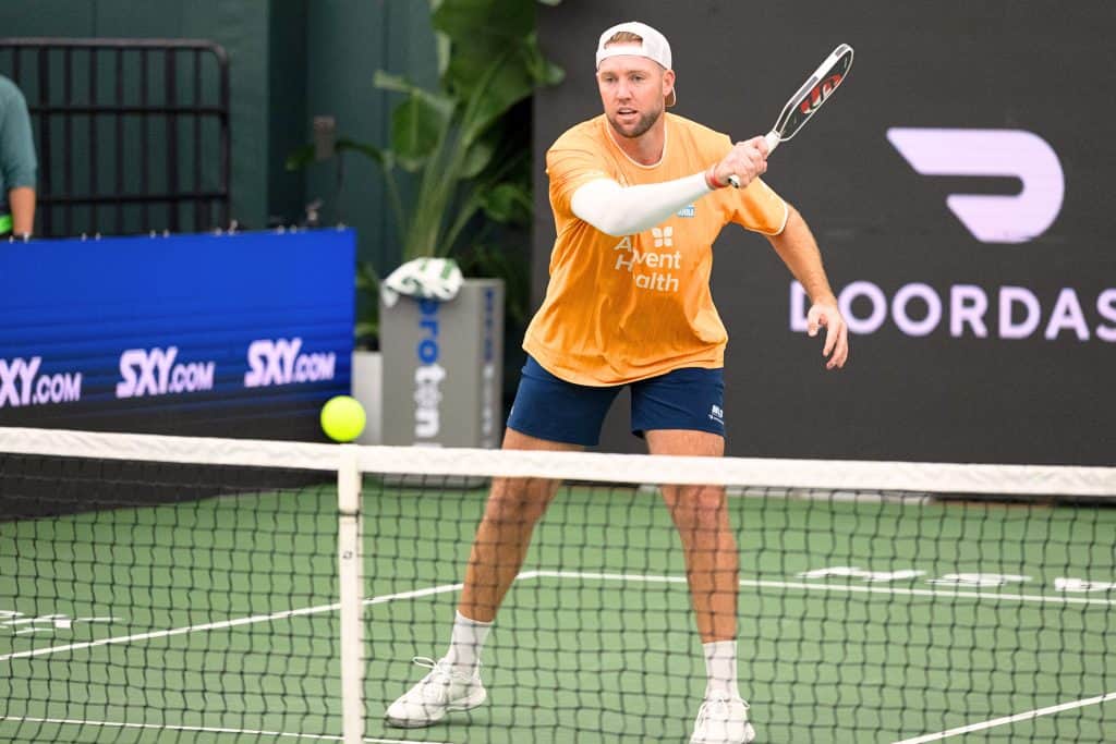 Pickleball player hitting ball during Major League Pickleball match.
