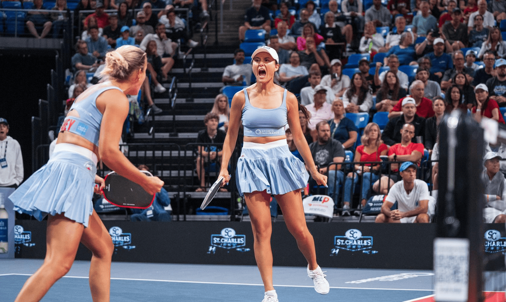 Two female pickleball players celebrating during a match at Major League Pickleball.