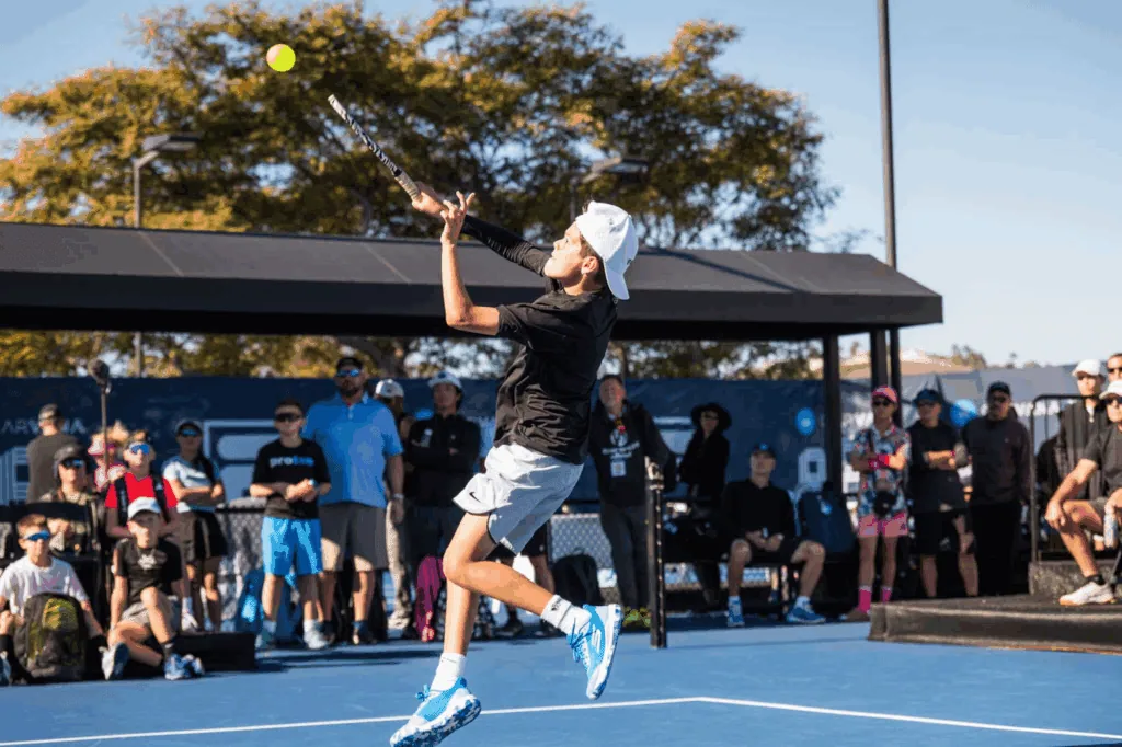 Player serving a pickleball during a match at Major League Pickleball event.